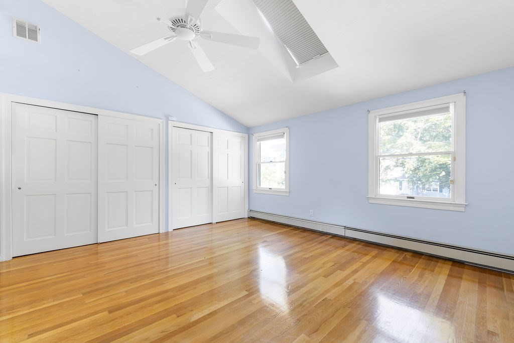 48 Taylor Street Needham, MA 02494 - Photo 13 of 25 an empty room with wooden floor chandelier fan and windows