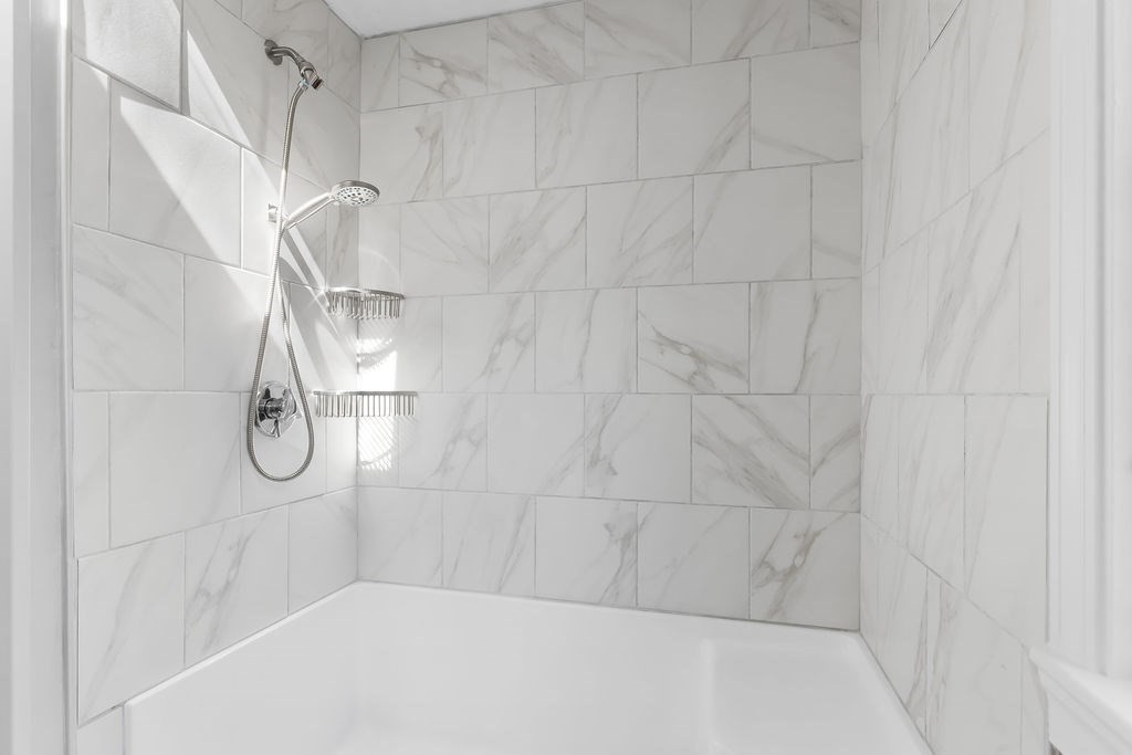 48 Taylor Street Needham, MA 02494 - Photo 16 of 25 a bathroom with a bath tub with a shower