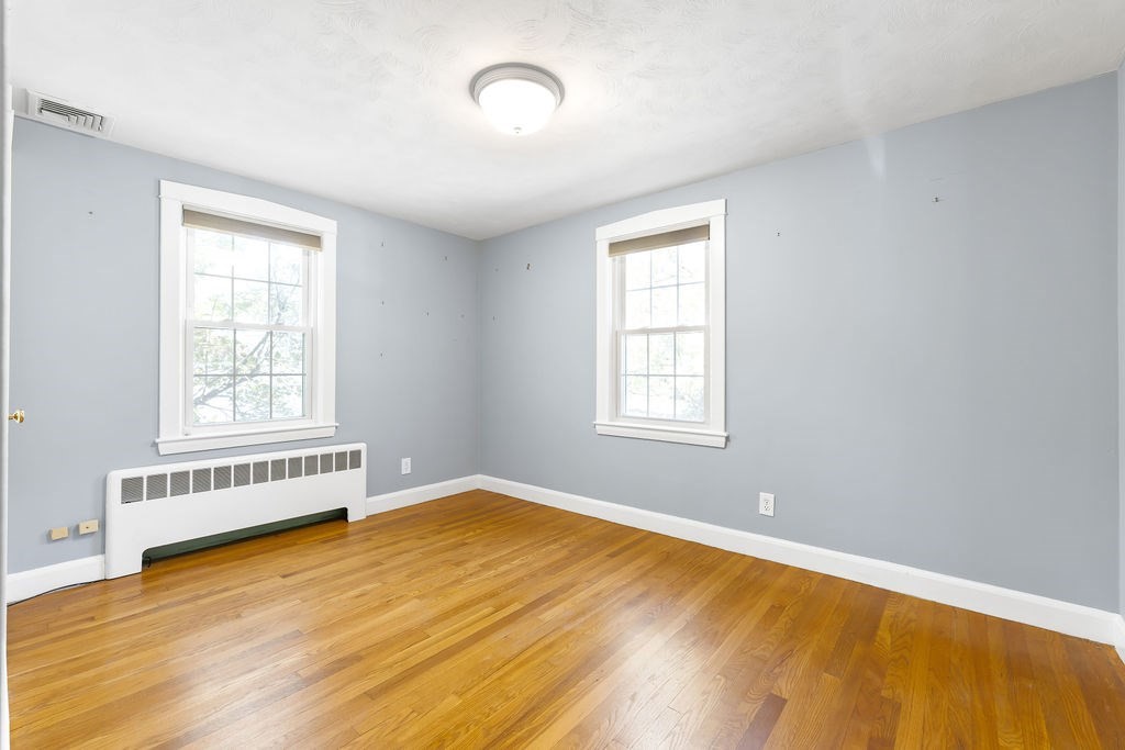 48 Taylor Street Needham, MA 02494 - Photo 17 of 25 a view of an empty room with wooden floor and a window