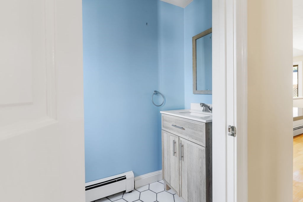 48 Taylor Street Needham, MA 02494 - Photo 19 of 25 a bathroom with a sink mirror and toilet