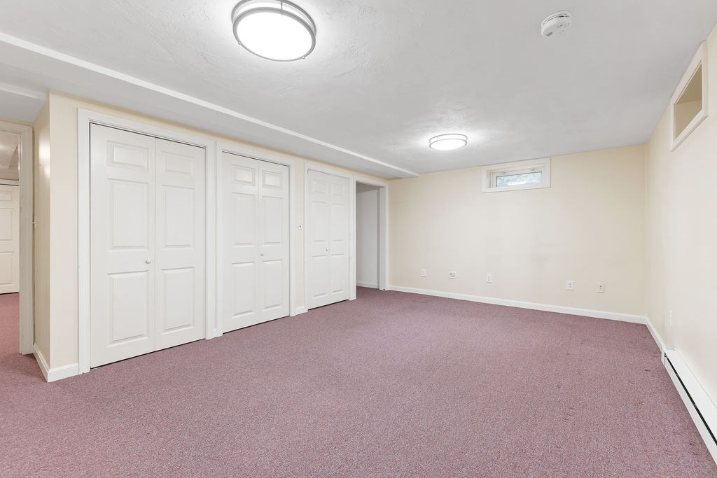 48 Taylor Street Needham, MA 02494 - Photo 22 of 25 an empty room with windows & cabinet view