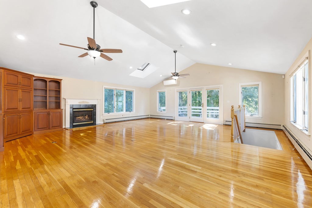 48 Taylor Street Needham, MA 02494 - Photo 4 of 25 a view of an empty room with a fireplace and wooden floor