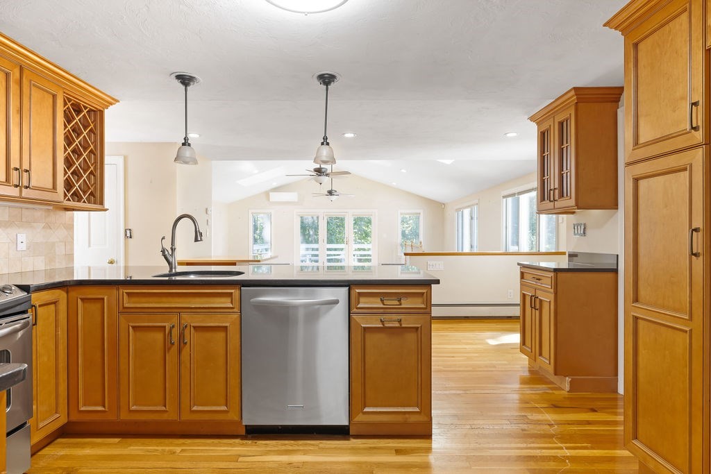 48 Taylor Street Needham, MA 02494 - Photo 7 of 25 a kitchen with stainless steel appliances granite countertop a sink a stove and a refrigerator