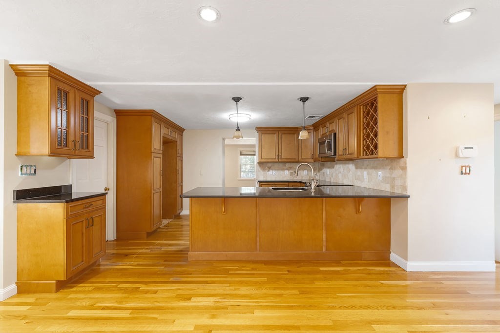 48 Taylor Street Needham, MA 02494 - Photo 10 of 25 a view of kitchen with stainless steel appliances granite countertop cabinets and wooden floor
