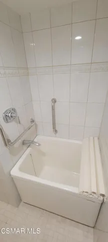 a white bath tub sitting in a bathroom