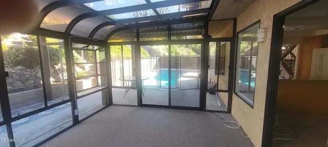 a view of an empty room with windows