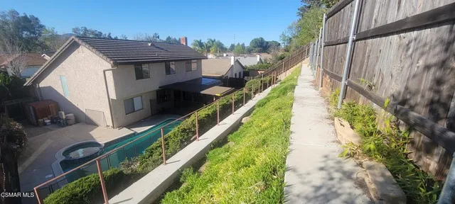 a balcony with view of an outdoor space