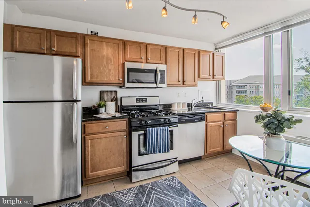 a kitchen with stainless steel appliances granite countertop a stove and a refrigerator