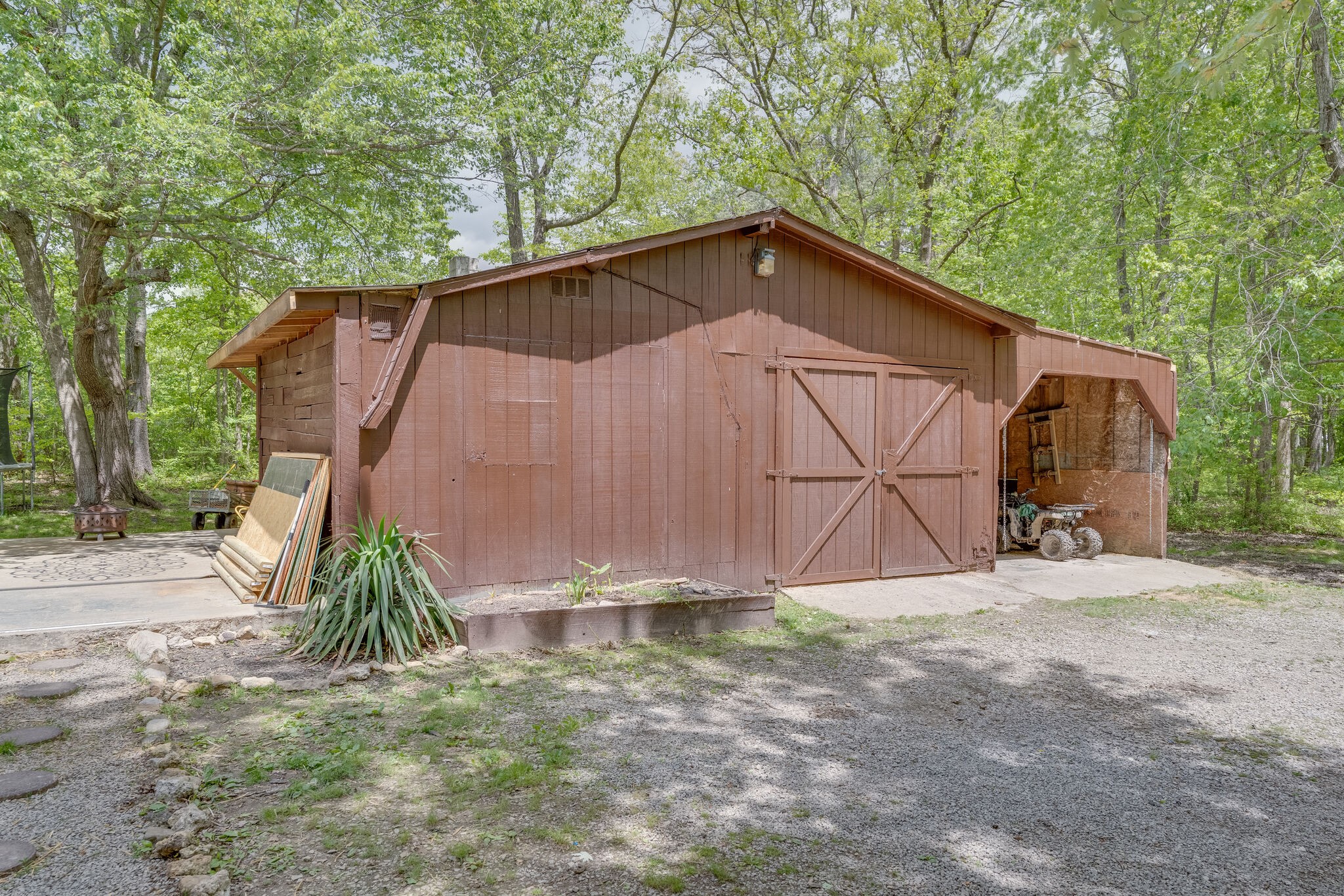 1883 Boynton Valley Road Manchester, TN 37355 - Photo 16 of 17 a backyard of a house with lots of trees and barbeque