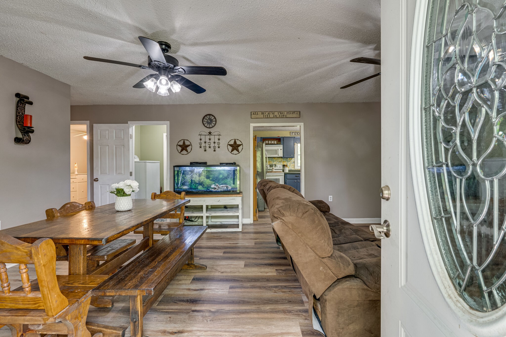 1883 Boynton Valley Road Manchester, TN 37355 - Photo 3 of 17 a dining room with wooden floor a chandelier fan a livingroom and furniture