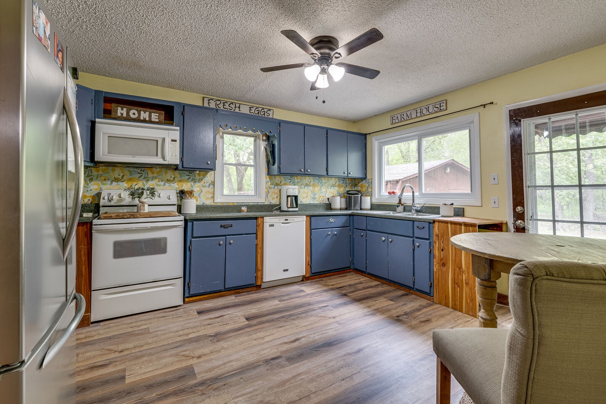 1883 Boynton Valley Road Manchester, TN 37355 - Photo 6 of 17 a kitchen with stainless steel appliances granite countertop a stove a sink dishwasher a refrigerator and a oven with wooden floor