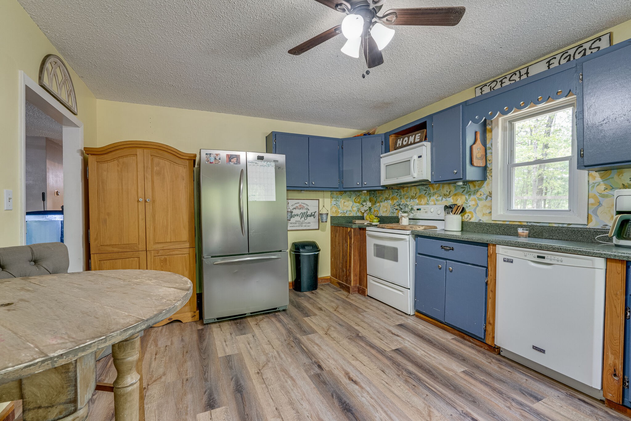 1883 Boynton Valley Road Manchester, TN 37355 - Photo 7 of 17 a kitchen with stainless steel appliances granite countertop a refrigerator a sink dishwasher a stove with wooden cabinets and floor