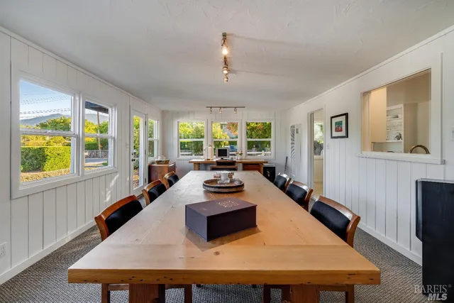 a kitchen with a table chairs and wooden floor