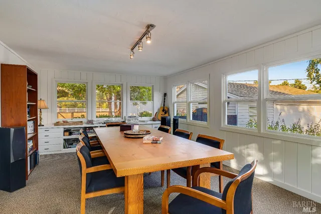 a view of a dining room with furniture a couch and wooden floor