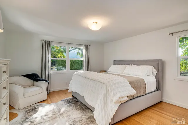 a bed sitting in a bedroom next to a window