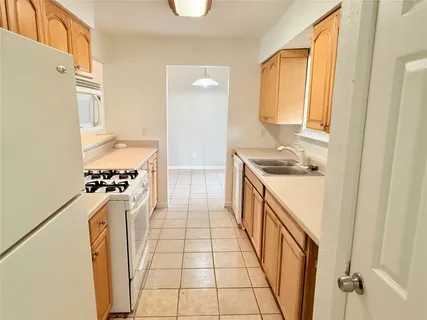 a kitchen with stainless steel appliances granite countertop a refrigerator and a stove