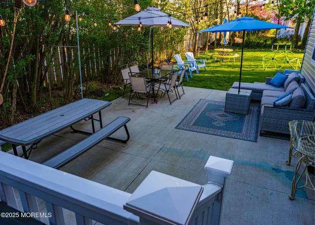 a view of a patio with a table and chairs under an umbrella