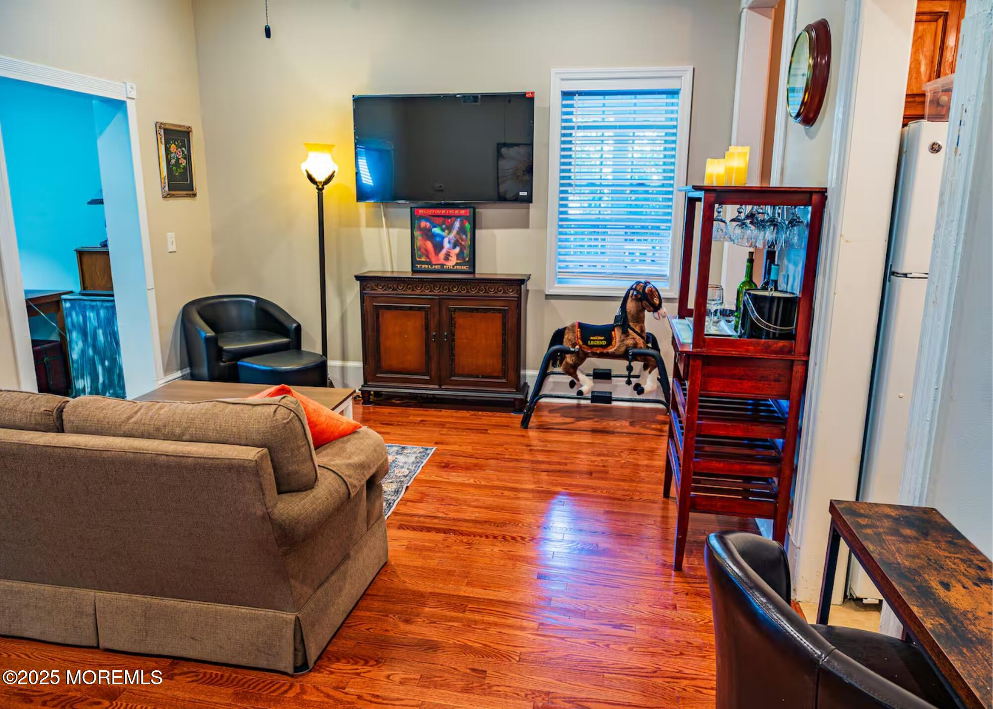 70 Bath Long Branch, Unit 1 Long Branch, NJ 07740 - Photo 6 of 22 a living room with furniture and a flat screen tv