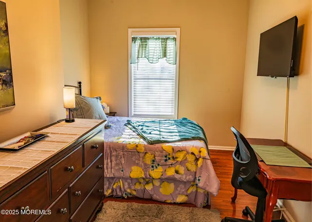 a bedroom with a bed and flat screen tv