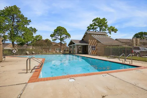 a view of a swimming pool with a lounge chair