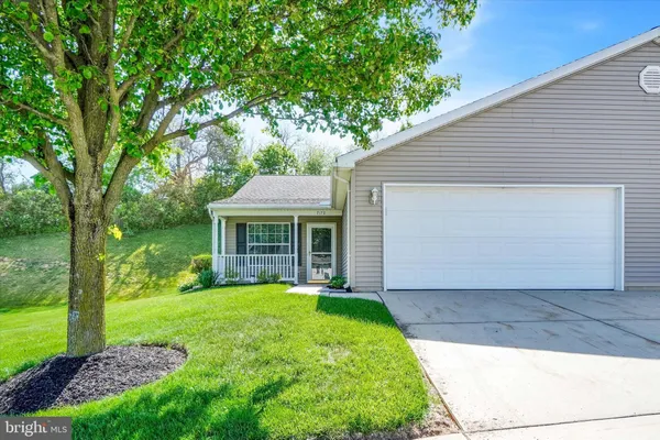a view of a house with yard and tree s