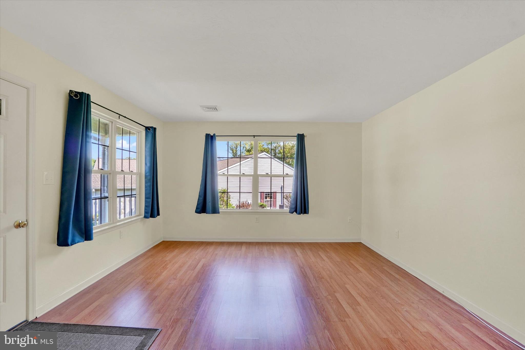 7172 Seneca Ridge Drive York, PA 17403 - Photo 3 of 18 an empty room with wooden floor and windows