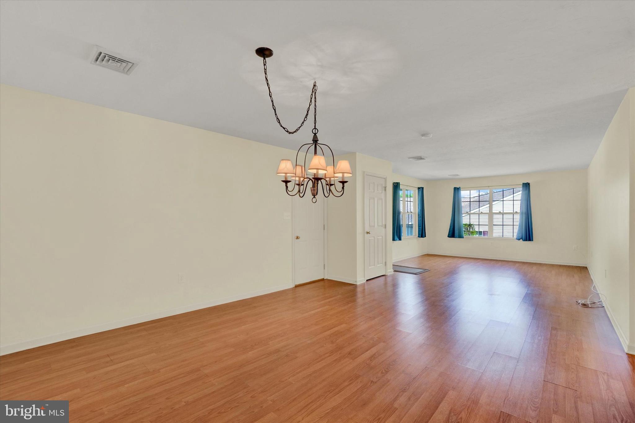 7172 Seneca Ridge Drive York, PA 17403 - Photo 5 of 18 a view of a room with wooden floor ceiling fan and windows