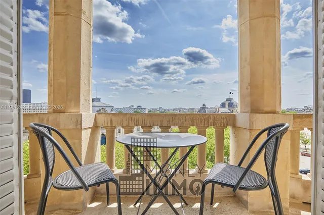 a view of a chairs and table in the balcony