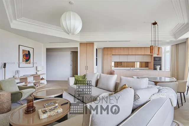 a living room with furniture and a chandelier