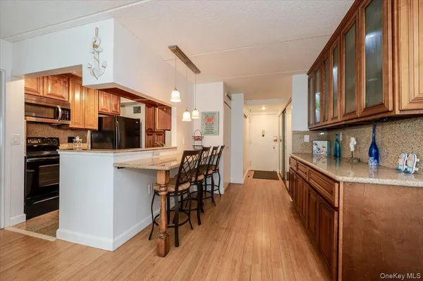 a kitchen with stainless steel appliances granite countertop a stove and a refrigerator