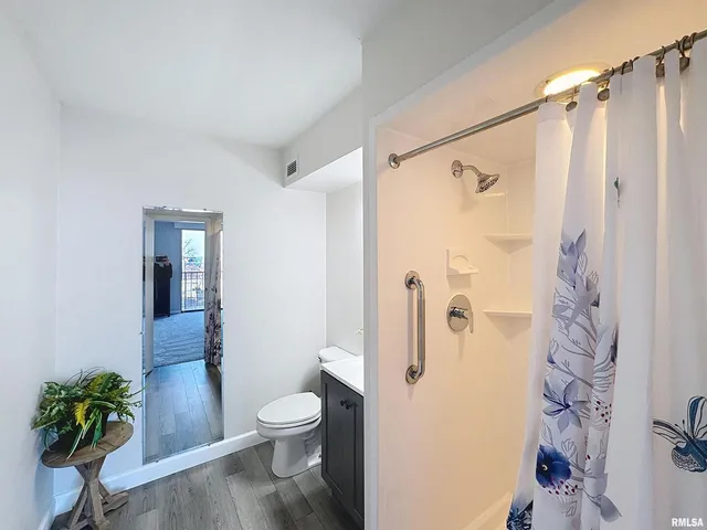a bathroom with a toilet a sink and shower