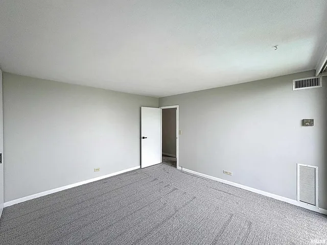 a view of an empty room and wooden floor