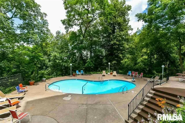 a view of a swimming pool with a lounge chair