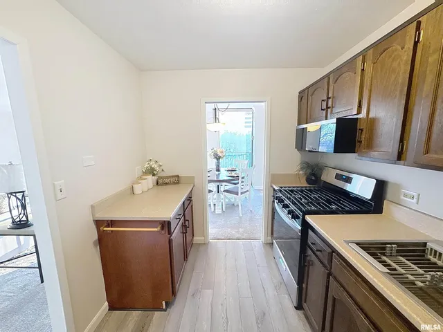 a kitchen with a stove and a refrigerator