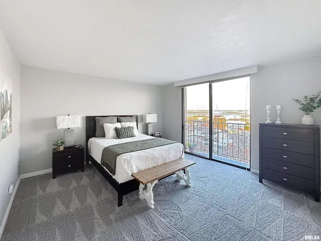 a spacious bedroom with a bed and a tv