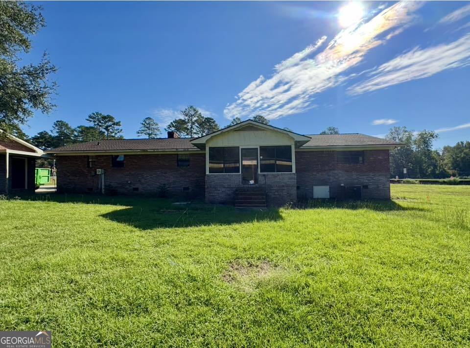 2471 Highway 441 Dublin, GA 31021 - Photo 16 of 18 a view of a house with backyard and a tree