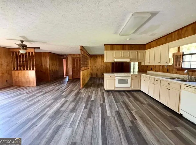 a kitchen with a sink and wooden floor