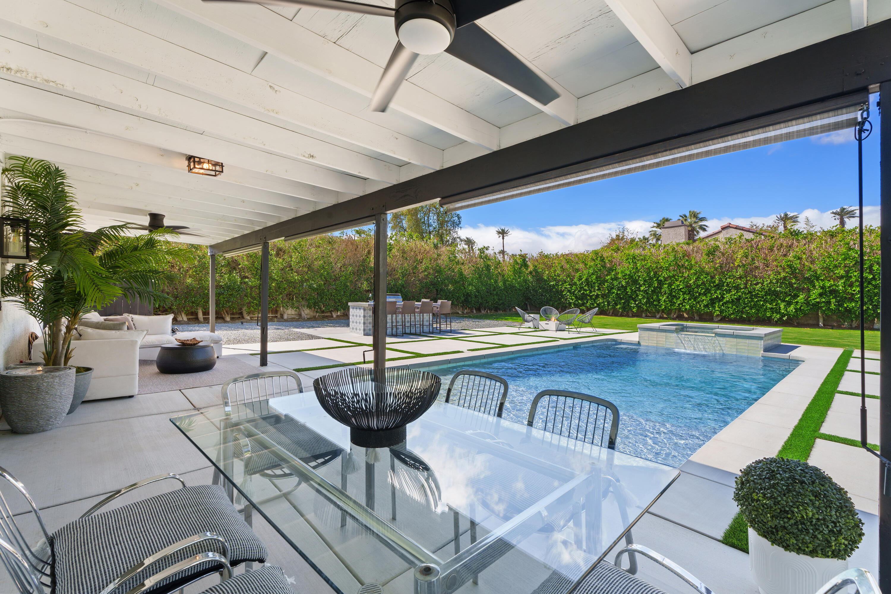 a view of swimming pool with outdoor seating and plants
