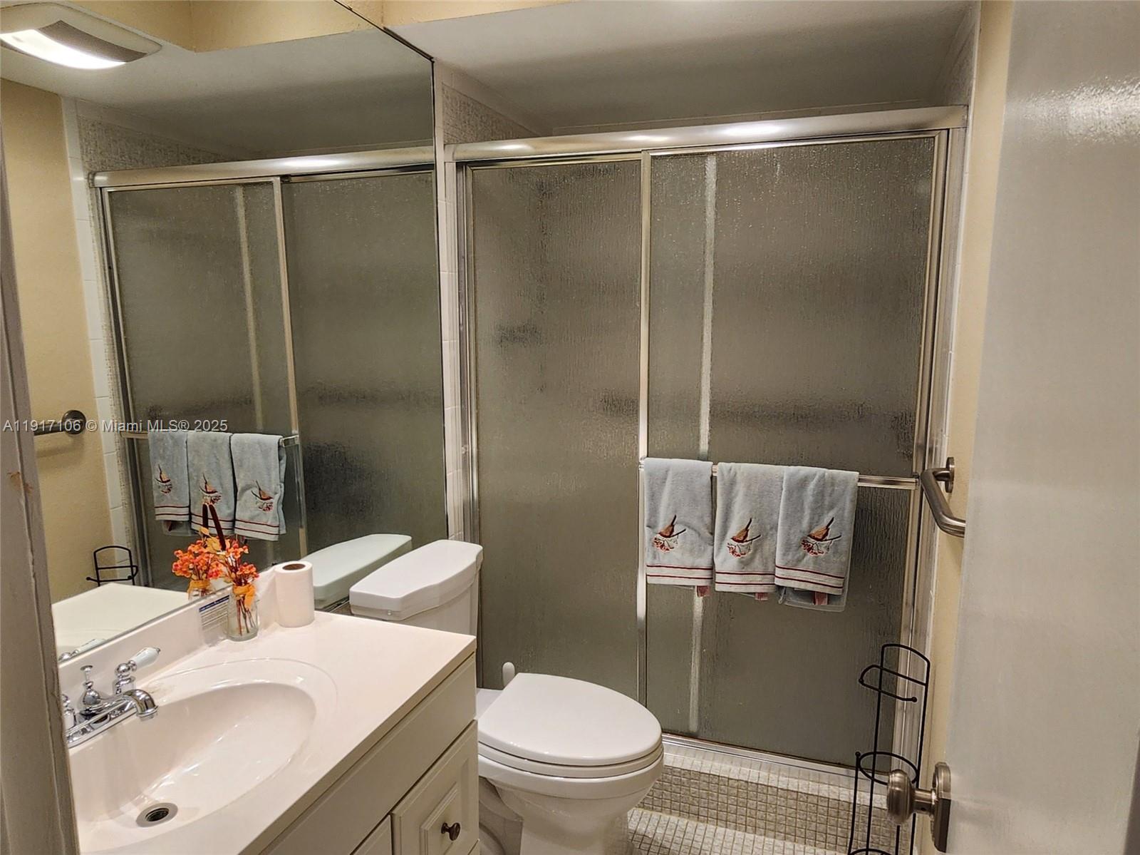 6731 Cypress Road, Unit 411 Plantation, FL 33317 - Photo 18 of 32 a bathroom with a sink toilet and shower