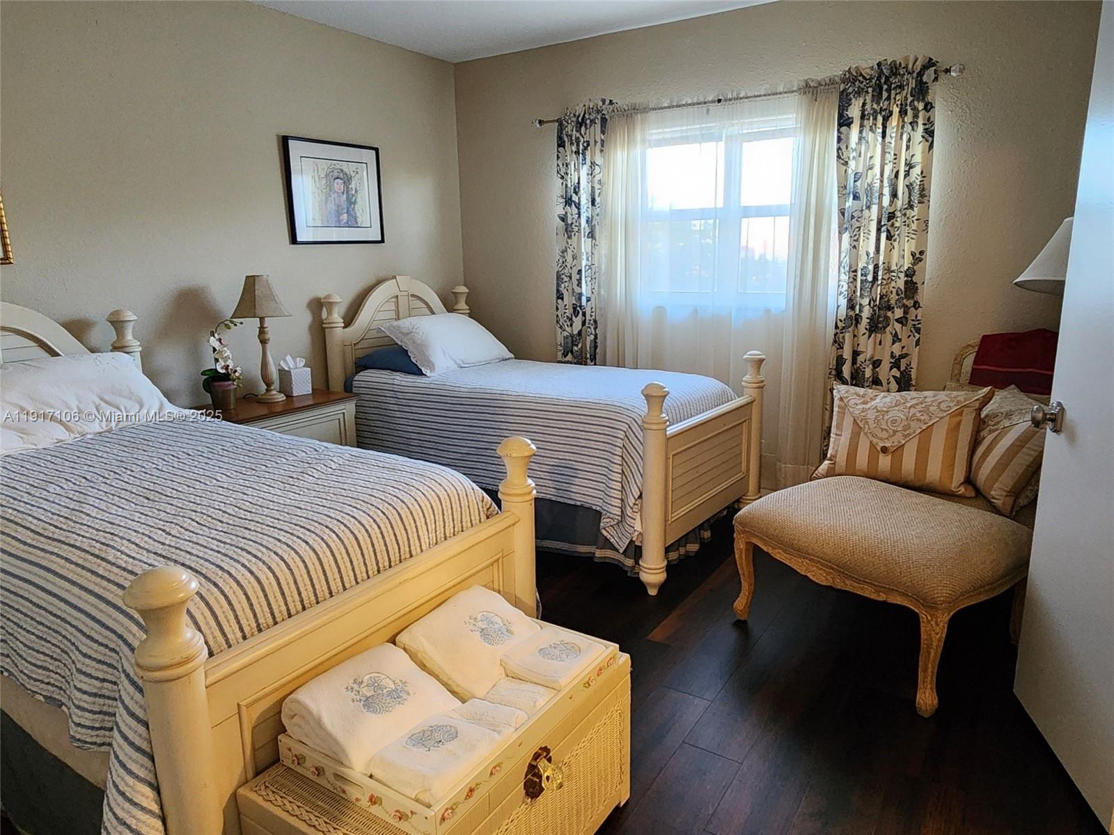 6731 Cypress Road, Unit 411 Plantation, FL 33317 - Photo 20 of 32 a bedroom with two beds and wooden floor