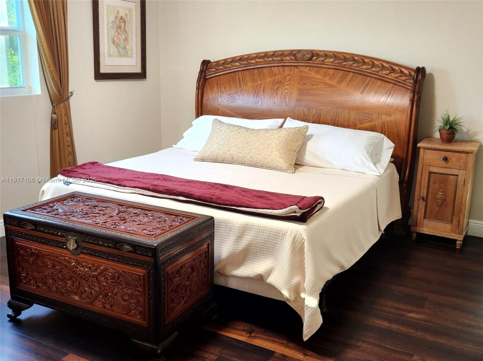 6731 Cypress Road, Unit 411 Plantation, FL 33317 - Photo 25 of 32 a bedroom with a bed and wooden floor