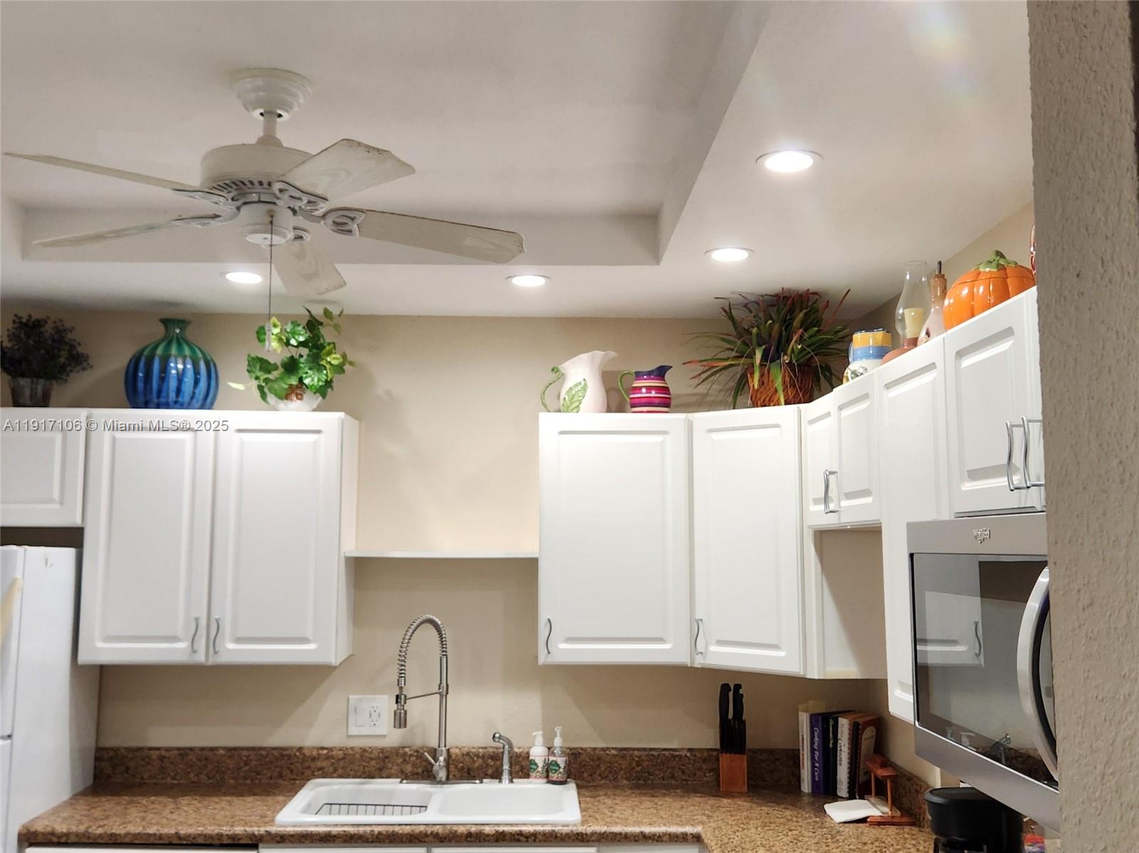 6731 Cypress Road, Unit 411 Plantation, FL 33317 - Photo 7 of 32 a kitchen with stainless steel appliances granite countertop a sink a stove and a refrigerator