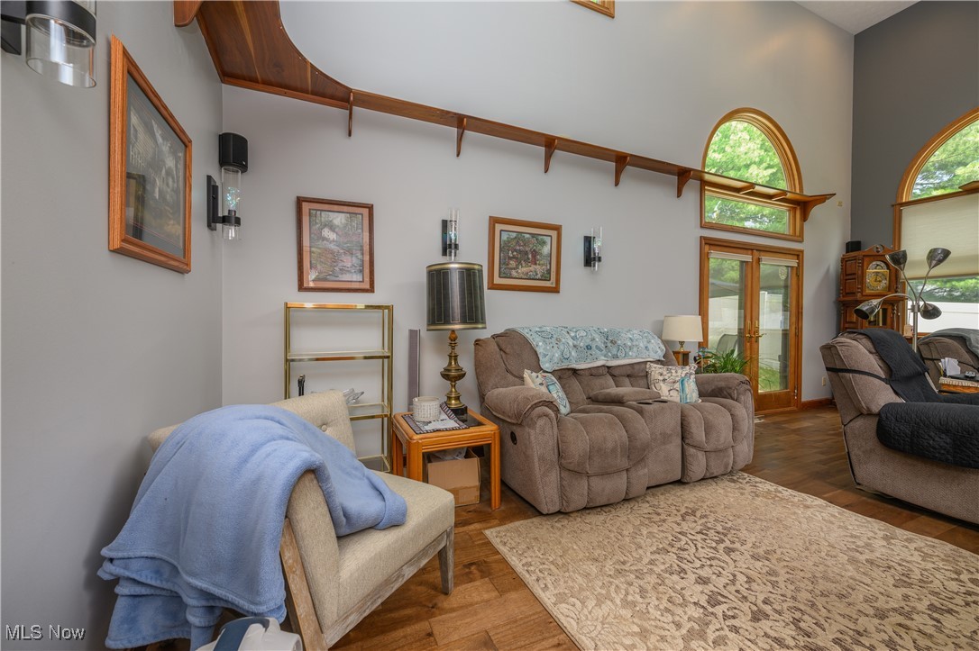 1427 Terrace Road Northwest New Philadelphia, OH 44663 - Photo 27 of 44 Living area with french doors, a high ceiling, and wood finished floors