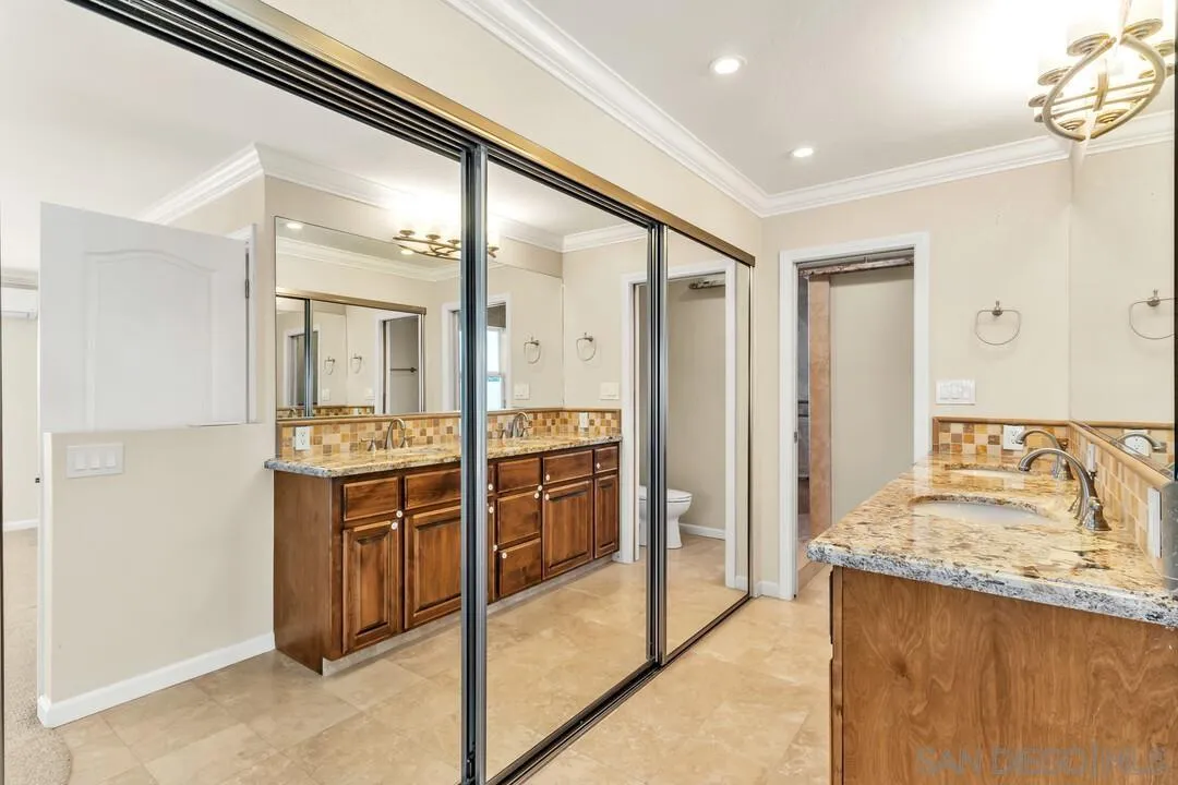 4502 Milton Street San Diego, CA 92110 - Photo 25 of 51 a bathroom with a granite countertop sink and a mirror