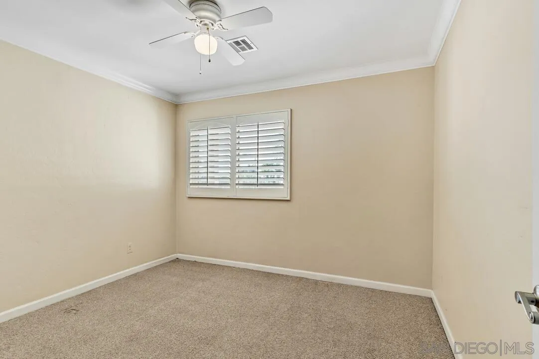 4502 Milton Street San Diego, CA 92110 - Photo 32 of 51 an empty room with a window and a ceiling fan
