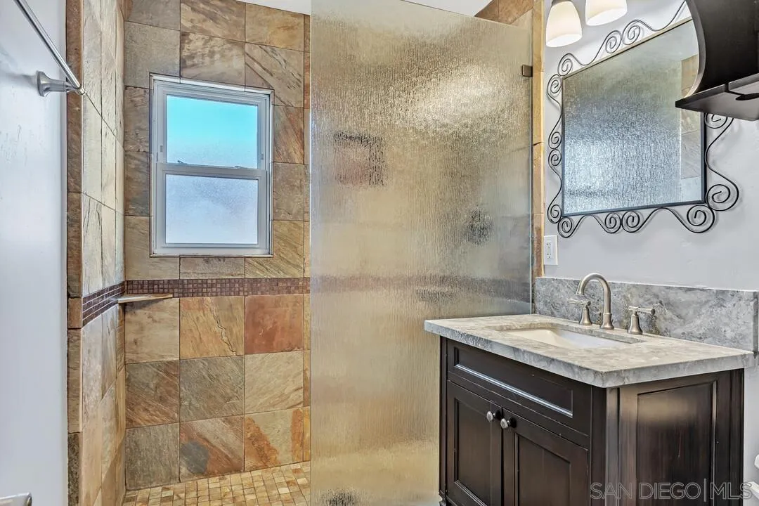 4502 Milton Street San Diego, CA 92110 - Photo 34 of 51 a bathroom with a sink and a mirror