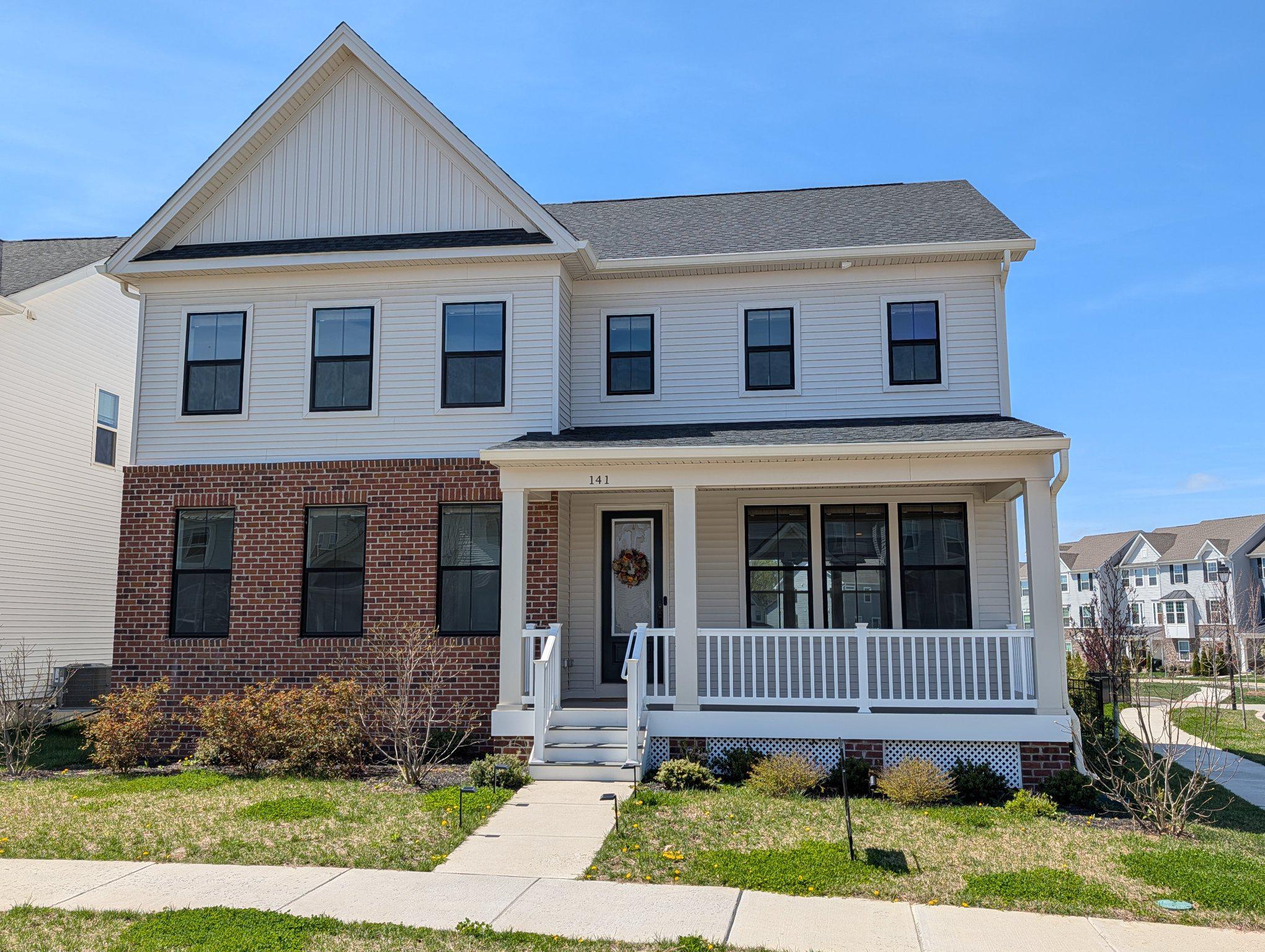 Charming two-story home with inviting porch.