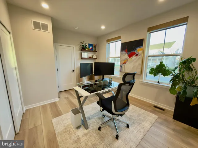 a workspace with furniture and a potted plant