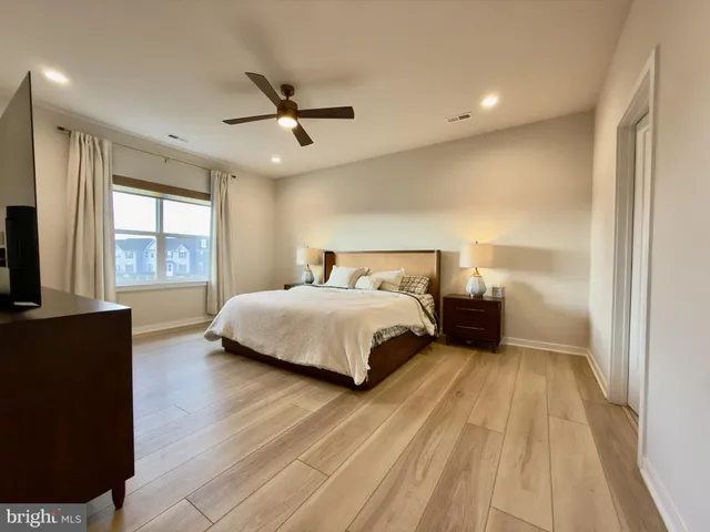 a bedroom with a bed and a large window