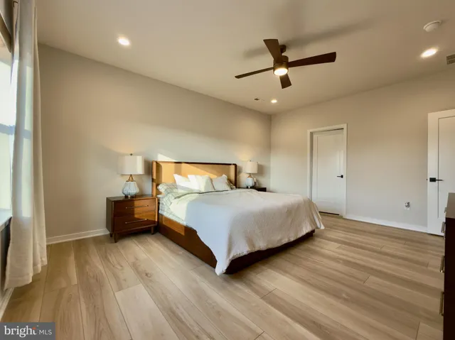 a bedroom with a bed and a ceiling fan